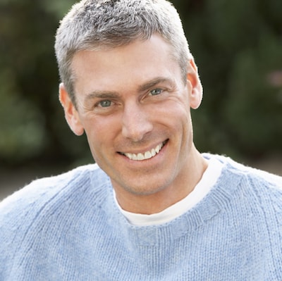 Headshot of an older man smiling about good endodontics in midtown New York