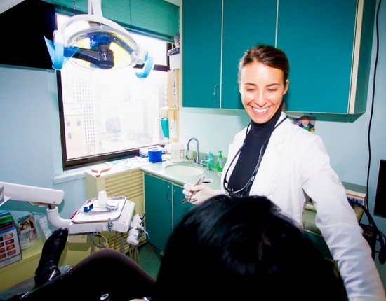 Our Midtown Manhattan dental office team member talking to a patient about dental crowns
