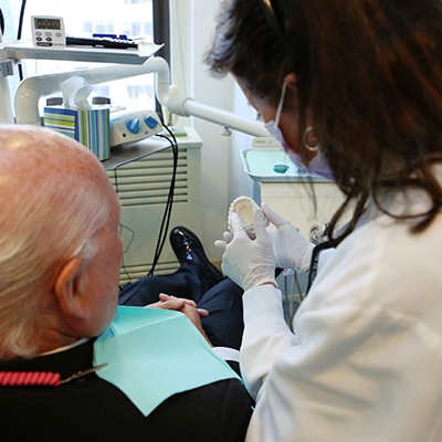 Candid shot of a doctor placing all-on-four dental implants in Lennox Hill New York